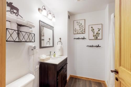 a white bathroom with a sink and a mirror at Tucker Mountain Lodge 307b in Copper Mountain