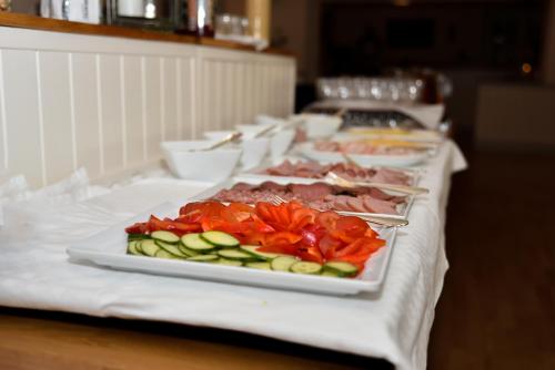 a row of plates of food on a table at Hotel Ullinge in Eksjö