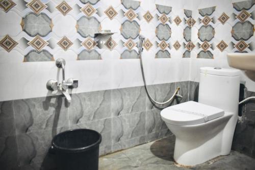a bathroom with a toilet and a sink at Hotel Unique Stays in Rājampet
