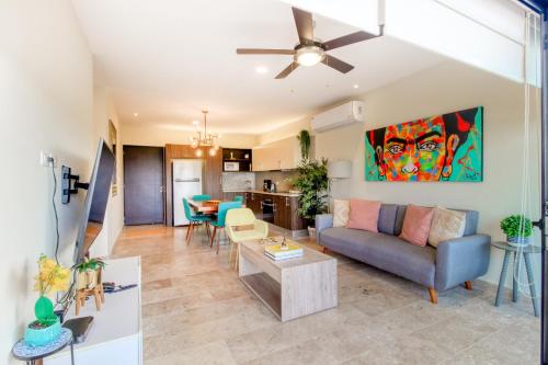 a living room with a couch and a table at Cocos 403 at Arenis in Playa del Carmen