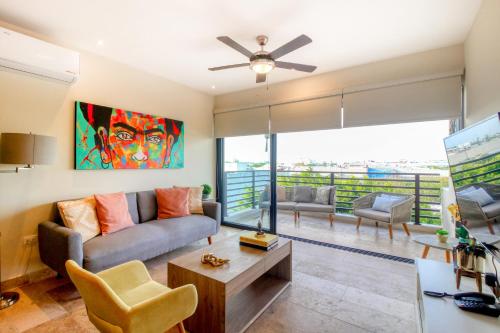 a living room with a couch and a table at Cocos 403 at Arenis in Playa del Carmen