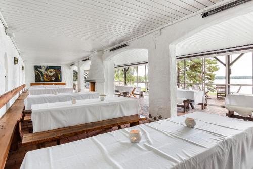 a large room with white beds and windows at Hotel Ullinge in Eksjö