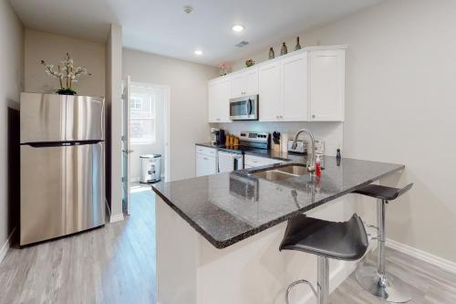a kitchen with white cabinets and a stainless steel refrigerator at Vinyards Terrace 3112 S Vineyards Terrace 1 in Branson