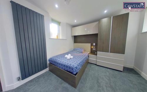 a bedroom with a bed with two pillows on it at New House - Magnificent Studios in Coventry City Centre, free parking, by COVSTAYS in Coventry