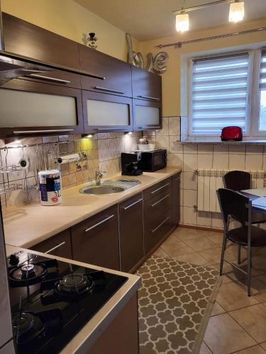 a kitchen with a sink and a stove top oven at 3-pokojowe mieszkanie do wynajęcia, Tylicz in Tylicz