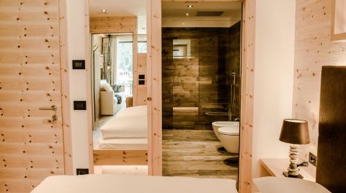 a bathroom with a sink and a toilet in a room at Garni Residence Soraiser in Selva di Val Gardena