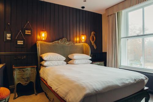 a bedroom with a bed with pillows on it at Crown Hotel in Stamford