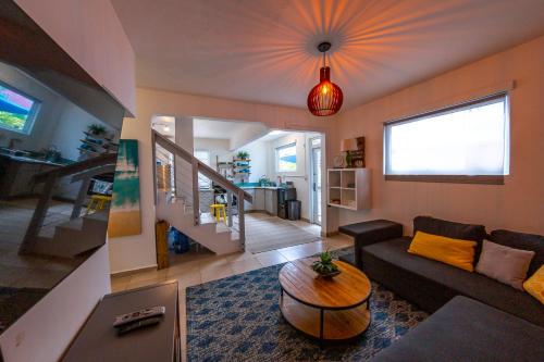 a living room with a couch and a table at Casa Verde Hotel in Rincon