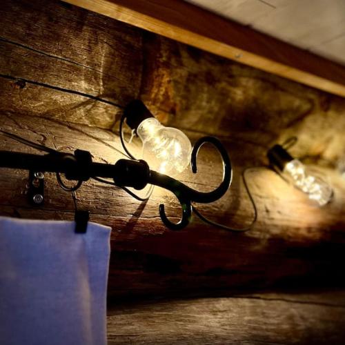 a pair of light bulbs on a wooden wall at Arctic Lodges Lapland Ski In Family Studio, Wi-Fi, National Park - Lapland Villas in Pyhätunturi