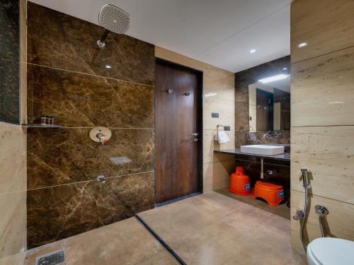 a bathroom with a shower and a sink at Golden Leaf Resort in Dhule