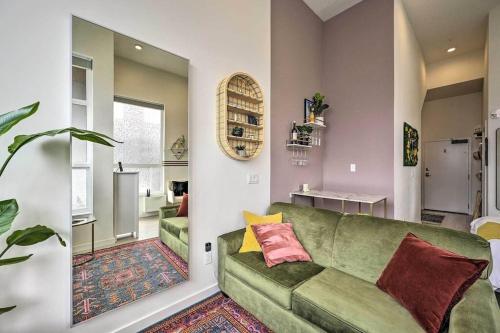 a living room with a green couch and a mirror at Stylish Ballard studio 15 mins from Space Needle in Seattle