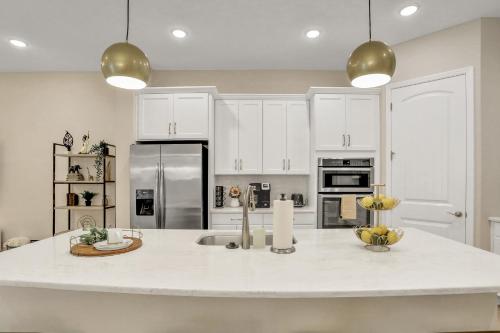 a kitchen with white cabinets and a large kitchen island at Newport Retreat in Tampa