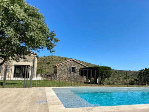a swimming pool in front of a house at Mas de Veyras - Gîtes 5 étoiles en Ardèche in Lachapelle-sous-Aubenas