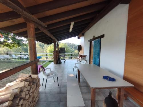 a room with a table and chairs on a patio at Alarpe Aterpetxea in Zaldivia