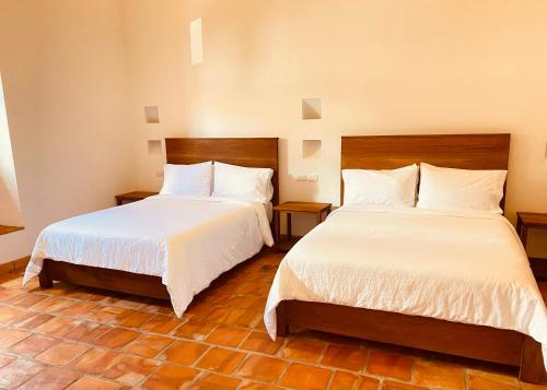 Una cama o camas en una habitación de Casa Santo Domingo Guadalupe Santander