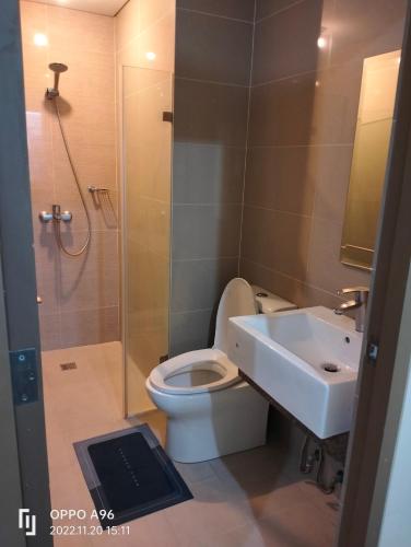 a bathroom with a toilet and a sink and a shower at Pasay Condotel Near Resorts World & Airport in Manila