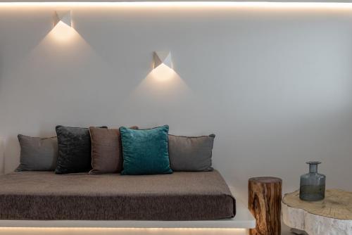a bed with two lights on top of it at Kasimatis by La Perla - Adults Only in Imerovigli