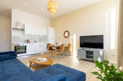 un salon avec un canapé bleu et une table dans l'établissement Super T2 (55 m2) proche du Cours Julien, à Marseille