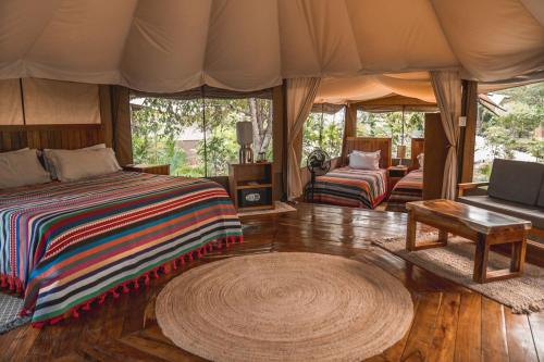 a bedroom in a tent with a bed and a table at Destino Mío by AKEN Soul 