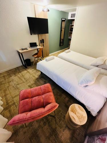 a room with two beds and a chair and a desk at HÔTEL KYRIAD MARSEILLE - Vitrolles Aéroport in Vitrolles