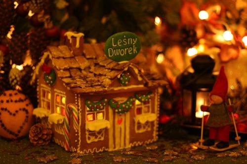 a gingerbread house with a santa hat on top of it at Leśny Dworek Zakopane in Zakopane