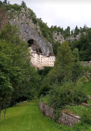 a building in a cave in a mountain at Sobe pri Roži in Postojna
