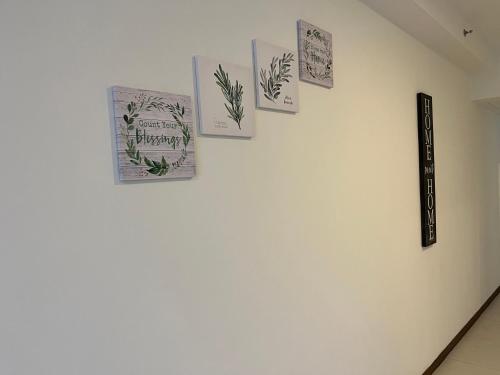 a wall with several cards on a white wall at The Landmark Comfort Relax Spacious Sea View By IZ in Tanjong Tokong