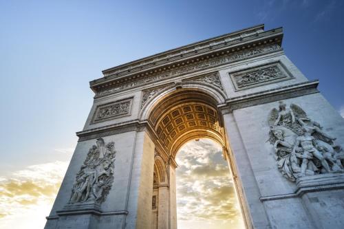 a tall arch with statues on it at Warwick Champs-Elysées Paris in Paris