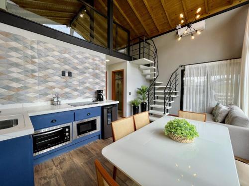 a kitchen and dining room with blue cabinets and a table at Alameda dos Ipês, casa completa, para toda família in Santo Amaro da Imperatriz