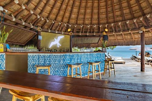 a bar on the beach with a view of the ocean at Fragata Island House in Cartagena de Indias