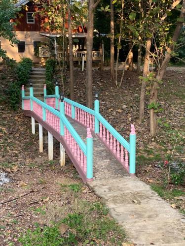 a pink and blue fence in a park at ทับศิลารีสอร์ท Tubsila Resort in Chongsadao