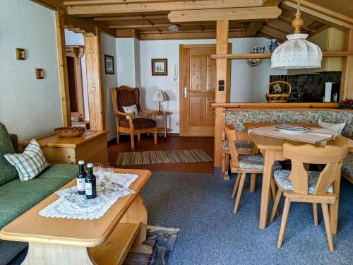 a living room with a table and a couch at Ferienwohnung Kaidisch - Reiter in Ruhpolding