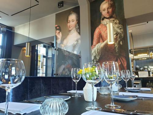 a table in a restaurant with wine glasses at Hotel Abdijhof Thorn in Thorn