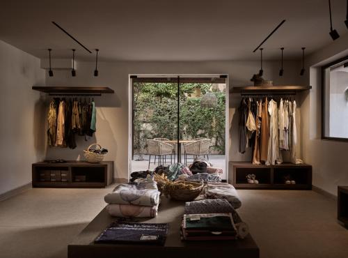 a living room with a couch and some clothes at Contessina Hotel in Tsilivi