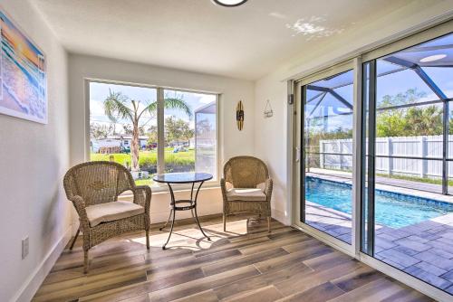 a living room with a table and chairs and a pool at Englewood Escape with Screened-In Pool and Grill! in Englewood