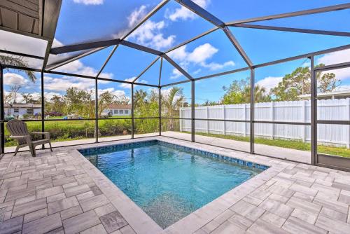 an indoor swimming pool in a house with a glass roof at Englewood Escape with Screened-In Pool and Grill! in Englewood