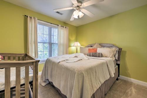 a bedroom with green walls and a bed with a ceiling fan at Wendell Home with Fenced Yard, Close to Raleigh in Knightdale