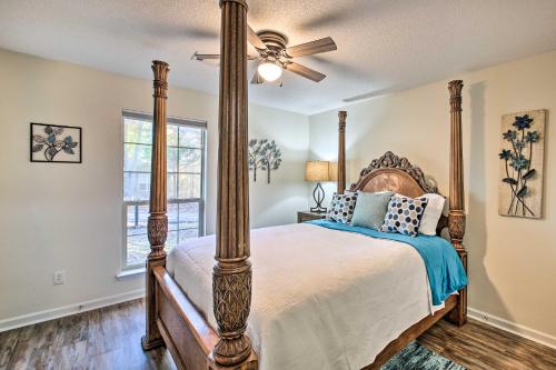 a bedroom with a bed and a ceiling fan at Tranquil Family Retreat with Fire Pit and Grill! in Hot Springs Village