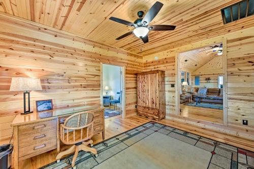 a log cabin office with a desk and a ceiling fan at Breathtaking Elkin Getaway with Vineyard Views! in Elkin