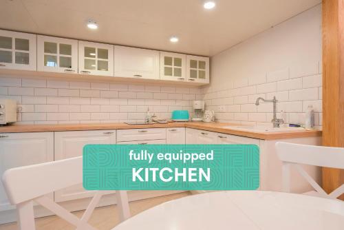 a kitchen with a sign that reads fully equipped kitchen at Revelton Suites Tallinn in Tallinn