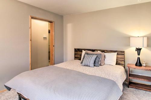 a bedroom with a bed and a lamp on a table at Idyllic Frazier Park Cabin Views, Pool Table in Frazier Park