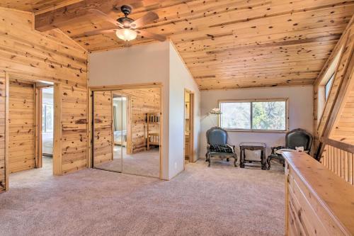 a dining room with a table and a ceiling fan at Idyllic Frazier Park Cabin Views, Pool Table in Frazier Park