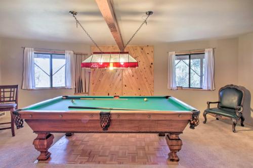 a living room with a pool table and a chandelier at Idyllic Frazier Park Cabin Views, Pool Table in Frazier Park