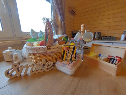 a kitchen counter with a basket of food on a table at Apartament z Tężnią Solankową, Sauną, Kominkiem LED i Śniadaniem nad Jeziorem Żywieckim in Zarzecze