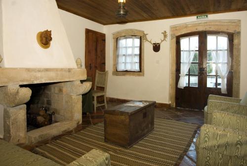 a living room filled with furniture and a fireplace at Quinta do Brejo - Turismo Equestre in Mafra