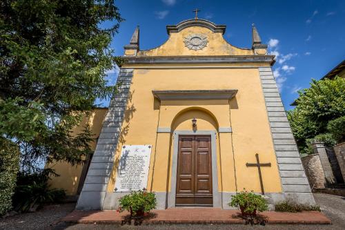 a small church with a clock on top of it at Villa S.Andrea in San Casciano in Val di Pesa