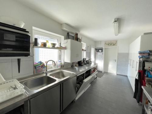 a kitchen with a sink and a stove at Lemmerhof in Eslohe