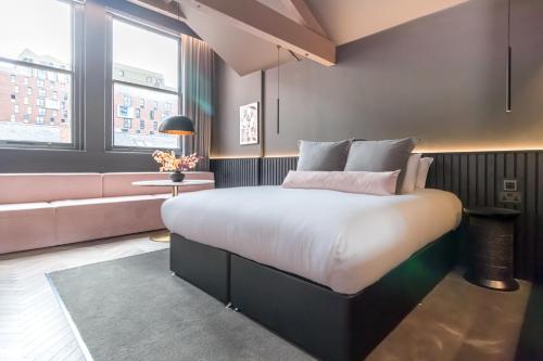 a bedroom with a large bed and a couch at Velvet Hotel in Manchester