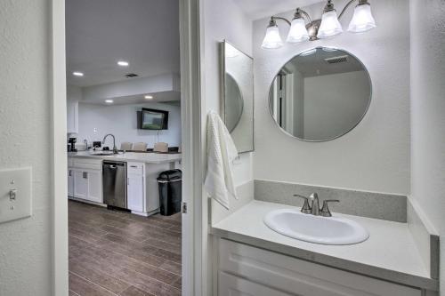 a bathroom with a sink and a mirror at Central Bakersfield Townhome with Private Patio in Bakersfield
