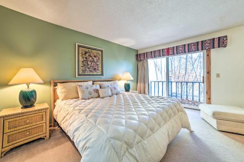 a bedroom with a large bed and a window at Bellaire Resort Condo Ski, Tube, Explore! in Bellaire